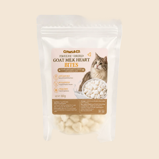 A 100g stand-up pouch of Claws & Co Freeze-Dried Goat Milk Heart Bites cat treats, featuring a white and brown label with a picture of a cat and the product name, set against a plain off-white background.