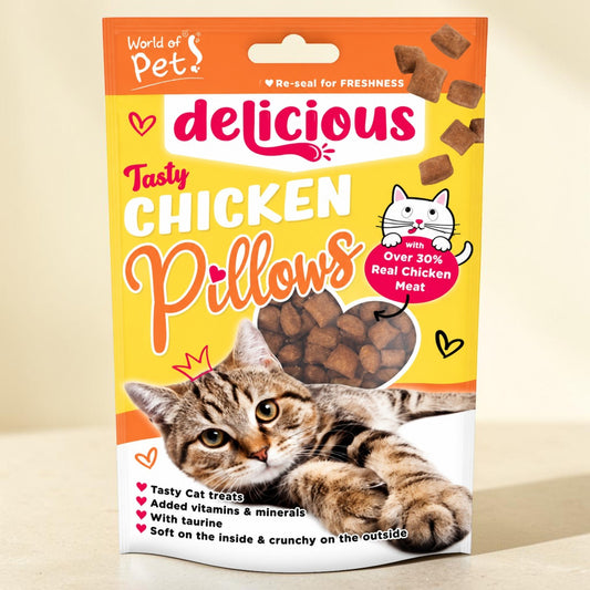 A bag of 'delicious' brand Tasty Chicken Pillows cat treats, featuring a tabby cat illustration on the front, set against a warm beige background.