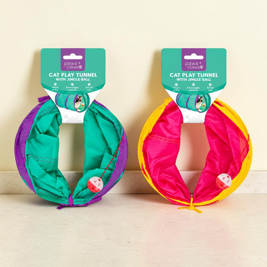 Two Power Cages cat play tunnels with jingle balls, one in teal, purple, and white, and the other in pink, yellow, and white, displayed side-by-side on a beige surface against a cream wall.