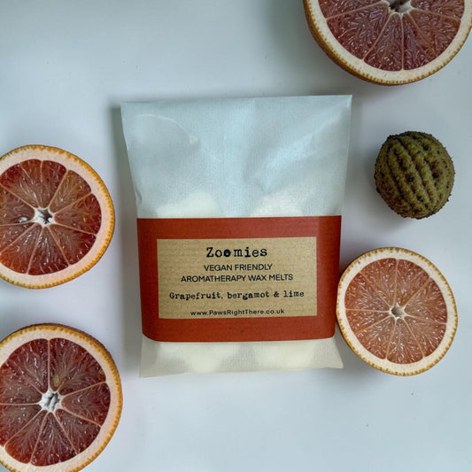 Pack of Zoomies vegan-friendly aromatherapy wax melts with sliced oranges and a ball on a white background
