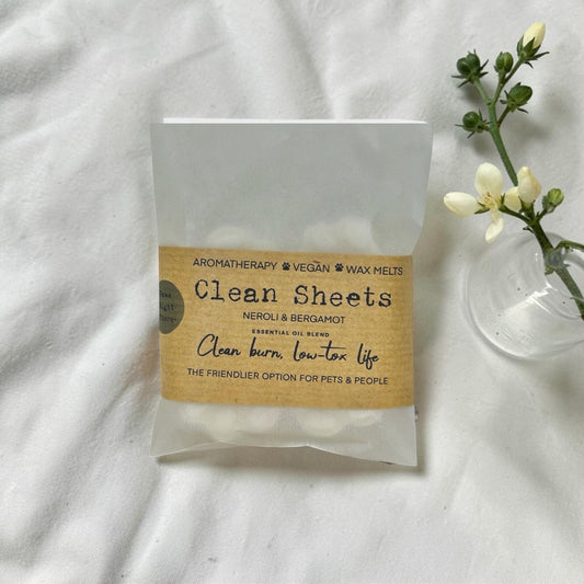 Pack of Clean Sheets wax melts with a label on a white fabric background