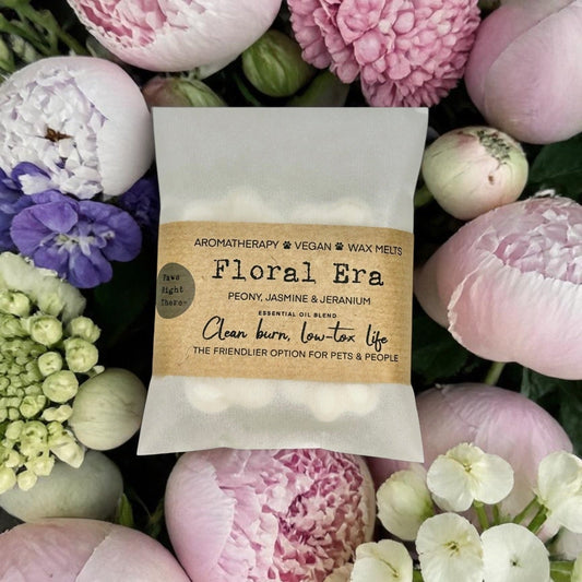 Floral Era wax melts packaging surrounded by flowers