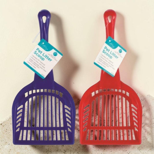 Two pet litter scoops shown side by side on a light beige wall and countertop. One scoop is purple and the other is red, both with attached paper tags labeled 'Pet Litter Scoop'.