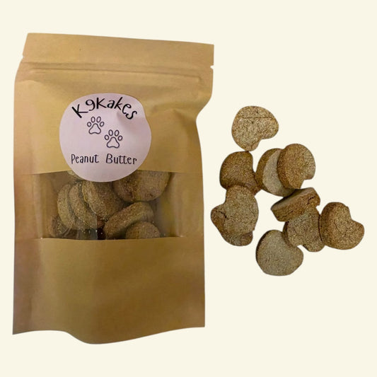 K9Kakes handmade peanut butter dog biscuits in a resealable pouch with individual treats displayed alongside.