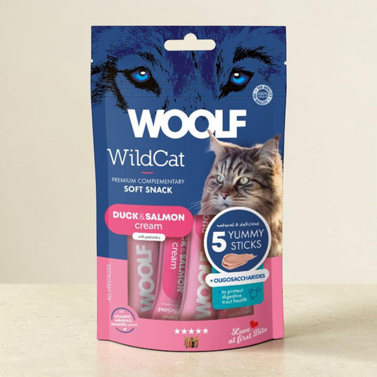 Woolf WildCat Duck & Salmon cream soft snack pouch with three pink tubes visible inside, shown on a light beige background.