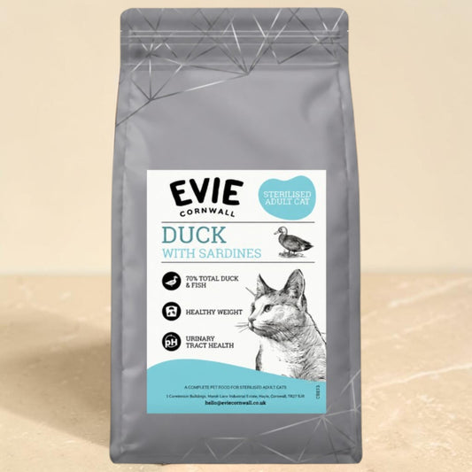 A bag of EVIE Cornwall Duck with Sardines cat food, featuring a gray pouch with a white and teal label, set against a neutral beige background.